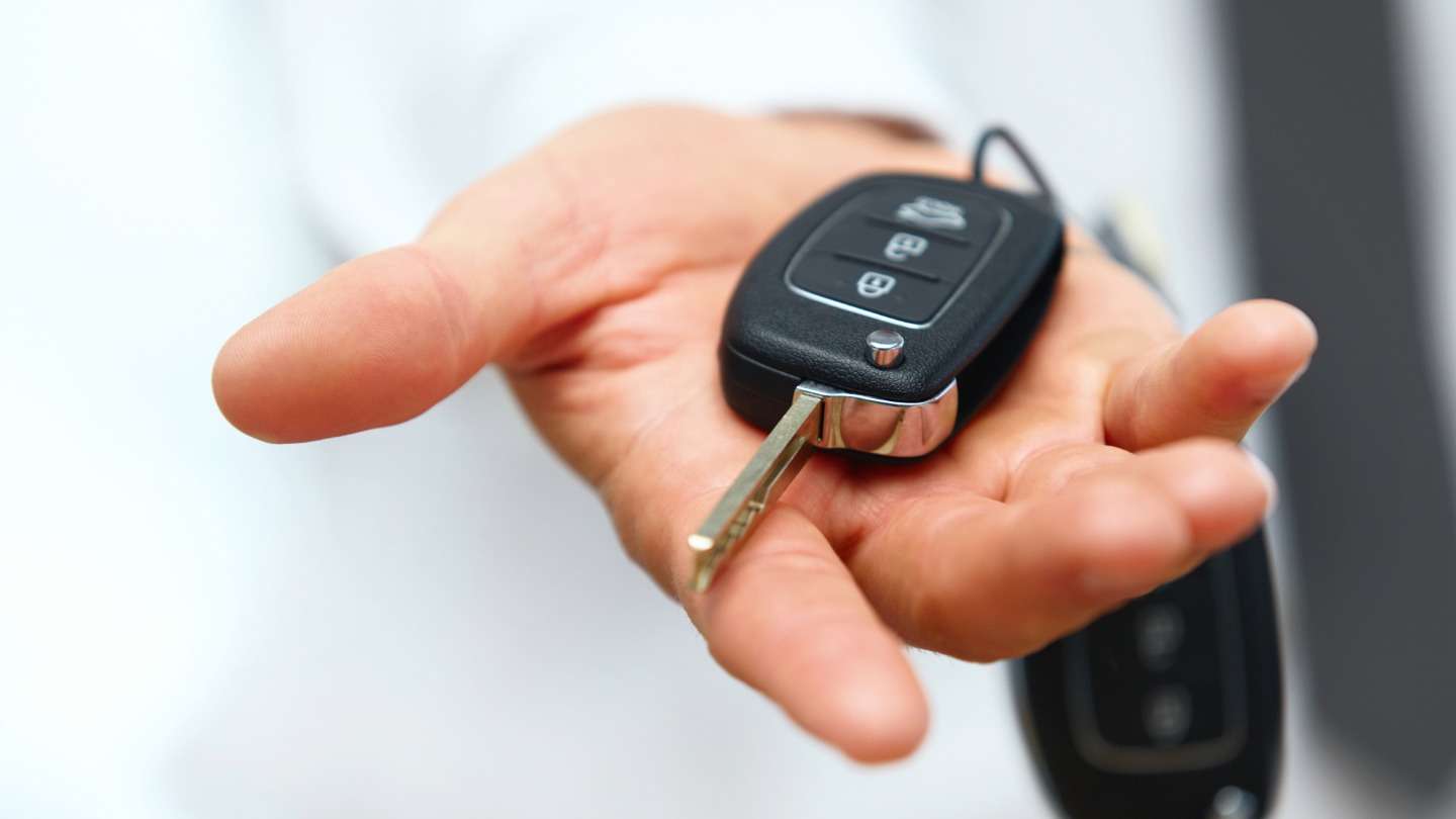 Close-up of a hand holding a car key